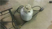 Propane tank with ice melter attachment