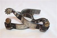 Silver overlaid roping spurs, brass buttons