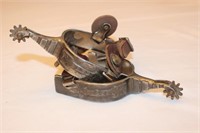 Silver overlay arrow roping spurs with straps