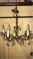 Antique brass chandelier with crystal prisms,