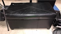 Black leather like storage bench full of all