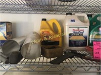 Assorted items on top shelf including horse shoe