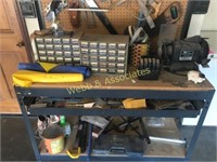 Large workbench with tools including nuts, bolts,