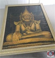 Framed picture of a seated Buddha in earth