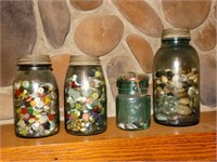 4 blue glass jars with buttons and stones