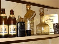 Shelf of decanters, wine rack, and partial can of