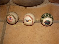 3 Baseballs, one is diamondback and two are New