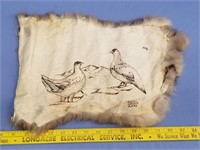 Rabbit pelt with a ink drawing of an ptarmigan by