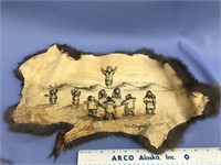 Tanned rabbit hide with an ink drawing of a blanke