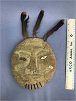 8 1/2" fossilized bone mask with feathers and ivor