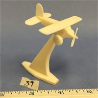 2 3/4" carved ivory airplane in midair on ivory ba