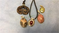 Five pendants, one 925 sterling with red stone,