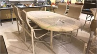 Oval patio table with four mesh arm chairs with