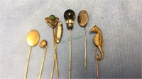 7 antique stick pins. Includes a seahorse, (834)