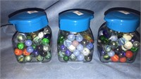 Three four-inch jars of marbles, (916)