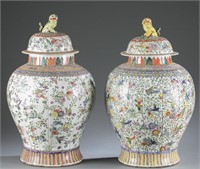 Pair of famille rose style jars with covers.