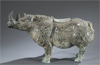 An archaic style bronze rhino container.
