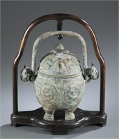 A Chinese bronze pot with stand.