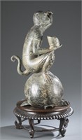 A bronze monkey sculpture.