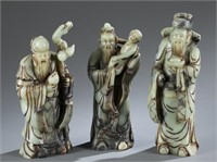 A group of three carved stone figures.