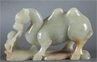 A Chinese celadon jade camel and child.