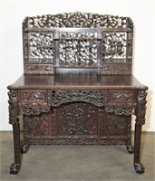 A carved hardwood writing desk.