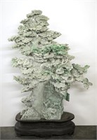 A Chinese carved jadeite pine tree.