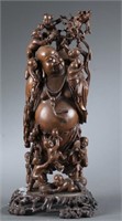 A Chinese carved wood Budai figure.