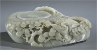 A carved celadon jade inkstone.