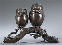 A bronze cast sculpture of owls.