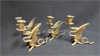 Set of four Griffin brass candlesticks