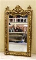 Floral Urn and Swag Accented Gilt Beveled Mirror.