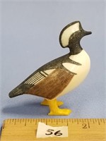 An impressive core ivory carving of a hooded merga