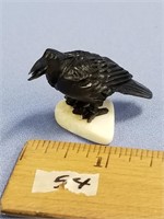An interesting ivory carving of a raven, all black