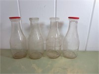 (4) One Quart Embossed Milk Bottles