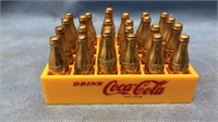 Coca-Cola crate of 24 cold Coca-Cola bottles, one