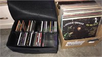 Box of vintage record albums and a CD case with