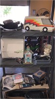 Three shelves of leftovers including a toy van