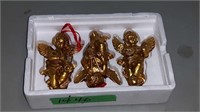 TRAY OF THREE PLASTER CHERUBS WITH INSTRUMENTS