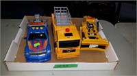 FLAT OF BATTERY OPERATED TOY TRUCKS AND EARTHMOVER