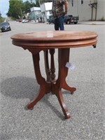 Ornate Oval Top Wood Parlor Table on Casters