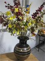 Black vase with artificial flowers