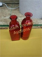 2 red decorative glass bottles
