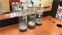 Three glass and stainless steel jars, barbicide