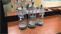 Three glass and stainless steel jars, barbicide