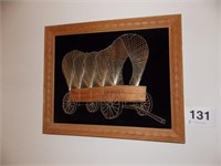 Nail and string art covered wagon on black felt