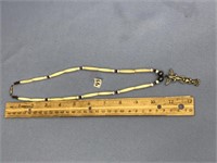 20" long Ivory bead necklace with a totem pole sty