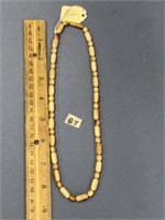 fossilized ivory necklace with round and pill shap