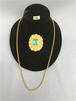 A 24" gold tone chain and a gold tone, cubic zirco