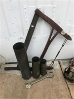 An antique hand saw, 3 brass mortar shells and a A